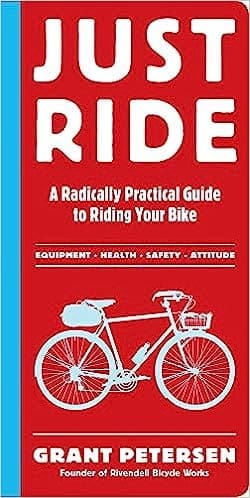 Cover image of the book 'Just Ride: A Radically Practical Guide to Riding Your Bike' by Grant Petersen, featuring a vivid illustration of a bicycle in a grey white outline against a red backdrop book coever.