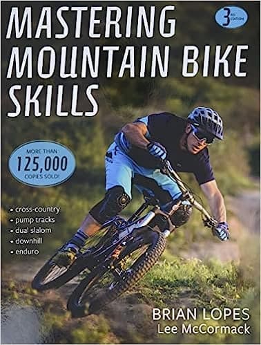 "Cover of "Mastering Mountain Bike Skills - 3rd Edition" by Brian Lopes and Lee McCormack, featuring a mountain biker navigating a rocky trail with precision and confidence.