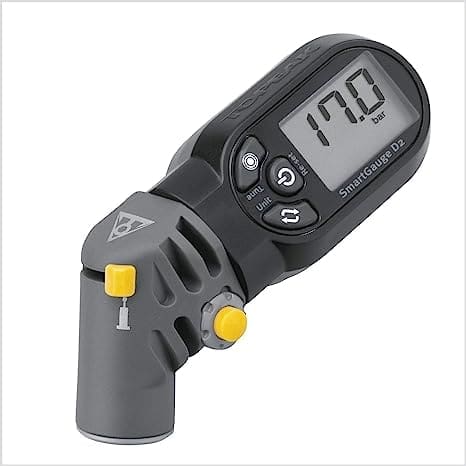 A Topeak D2 SmartGauge digital tire pressure gauge with a rotating head, compatible with Presta and Schrader valves, featuring a backlit LCD screen displaying accurate tire pressure measurements.