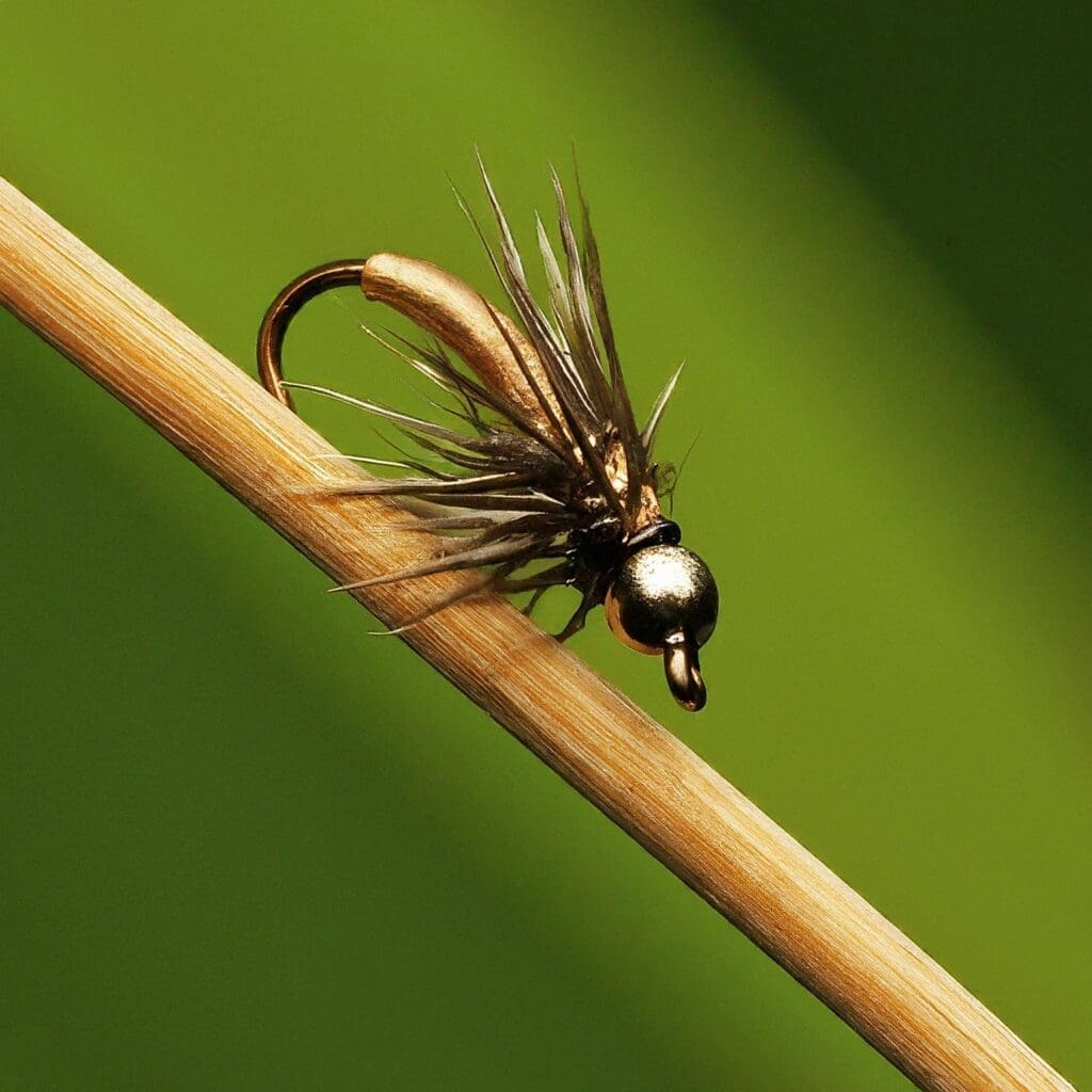 Image of an olive bead-head nymph fly, designed to imitate underwater insect life for fishing.