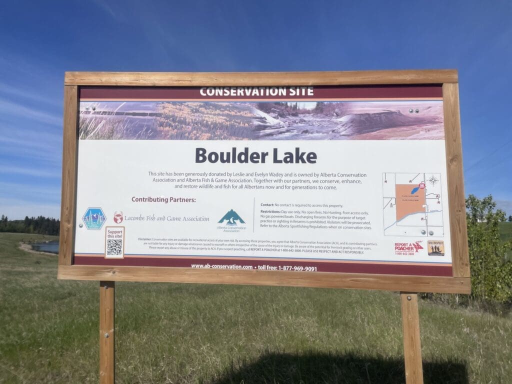 Boulder Lake conservation sign detailing the Wadey donation, management by Lacombe Fish and Game Club.