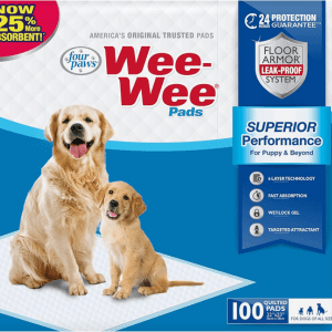 A golden retriever and puppy sit next to a package of Four Paws Wee-Wee Pads.